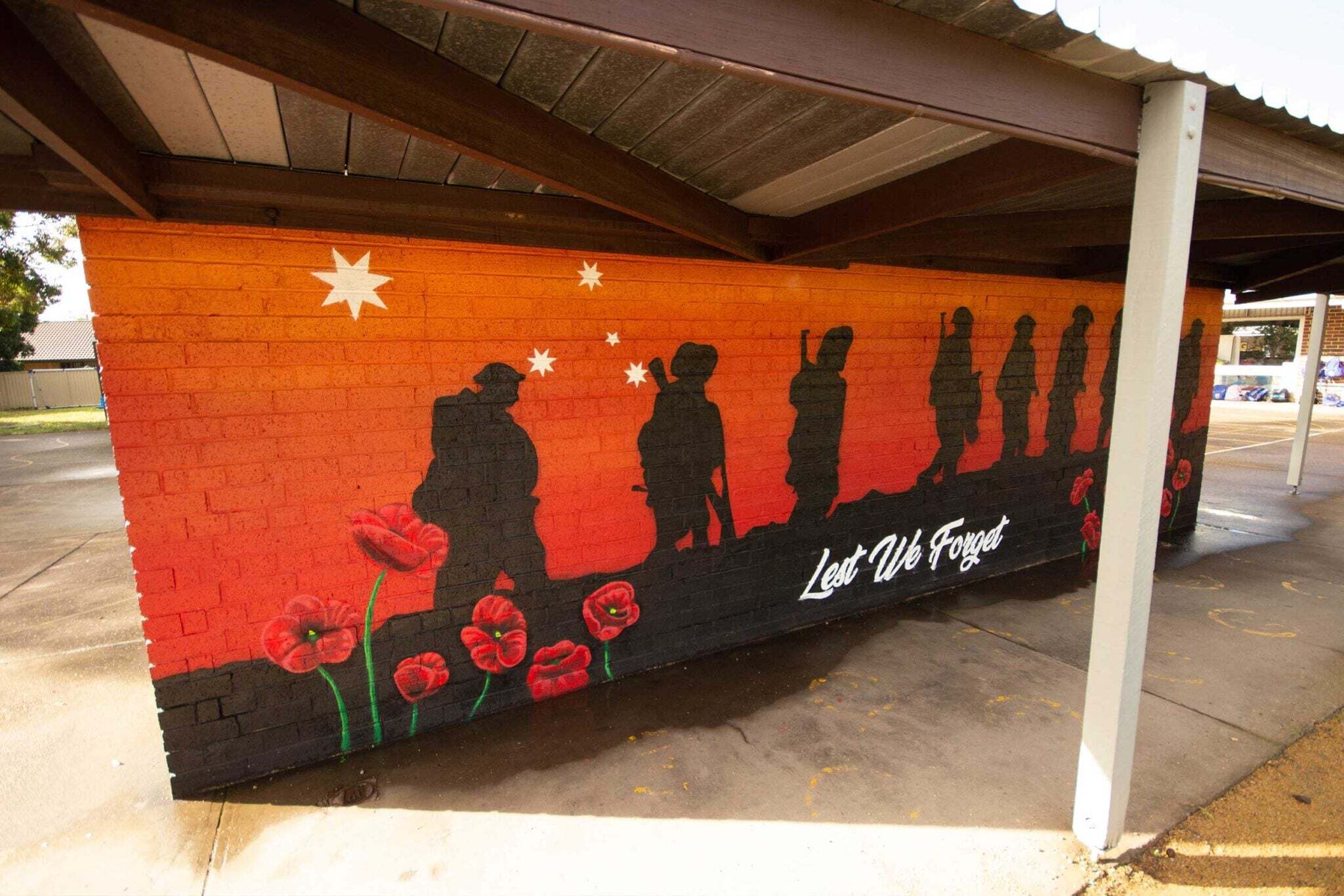 Mural honoring Anzac soldiers and poppies.