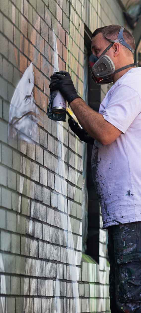 Australian Mural Artists - Blackbook Ink painting a school mural in South West Sydney